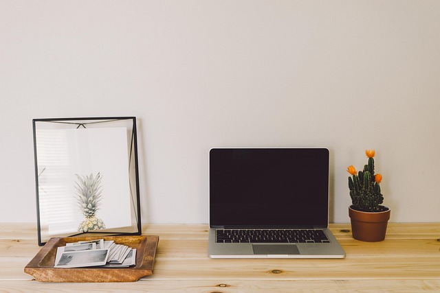 checklist notebook next to laptop with organized files and calm workspace